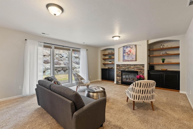 carpeted living room with visible vents, built in shelves, a fireplace, and baseboards