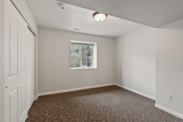 unfurnished bedroom with carpet flooring, baseboards, and a closet