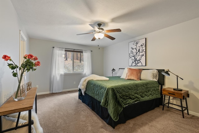 carpeted bedroom with baseboards, a textured ceiling, and ceiling fan