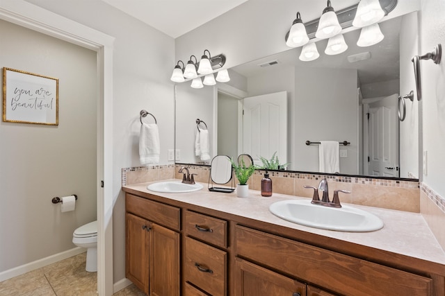 full bath featuring a sink, toilet, double vanity, and tile patterned flooring