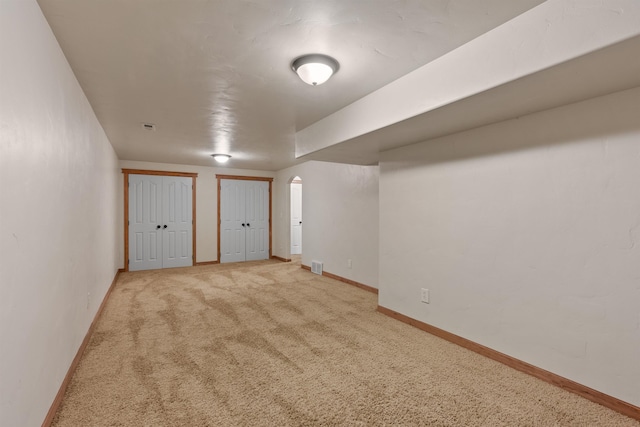 below grade area with visible vents, baseboards, and carpet flooring