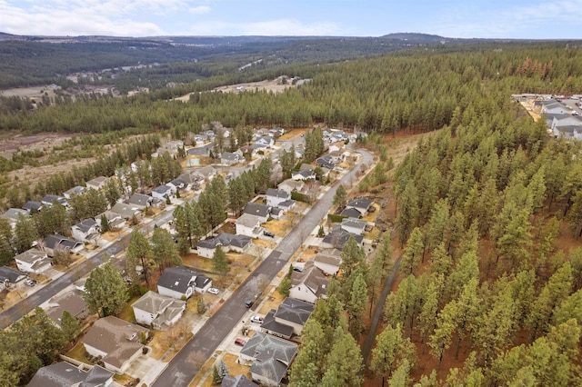 aerial view featuring a residential view and a wooded view