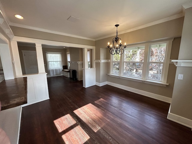 unfurnished dining area with a fireplace, crown molding, baseboards, and dark wood-style flooring