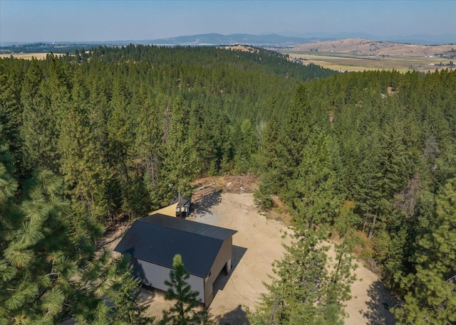 aerial view featuring a mountain view and a wooded view