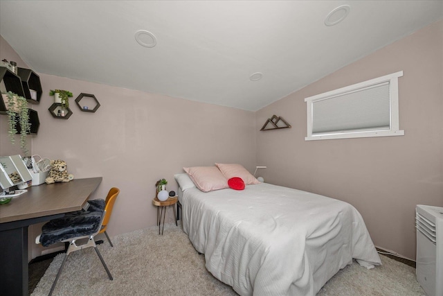 bedroom featuring lofted ceiling and light carpet