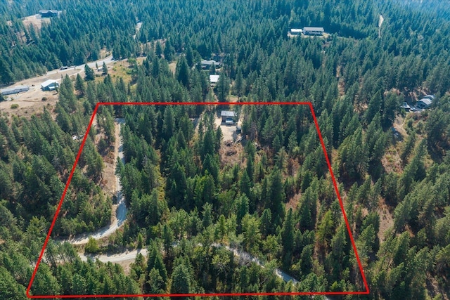 birds eye view of property with a view of trees