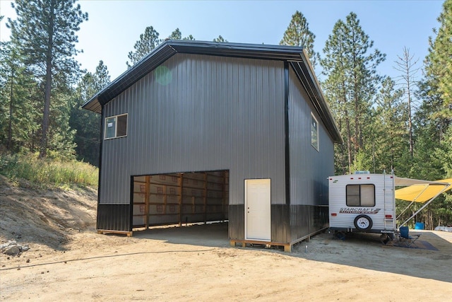 view of side of home featuring an outbuilding