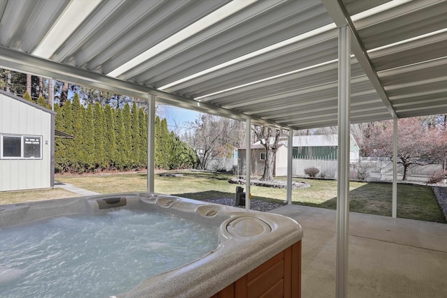 view of patio / terrace with a fenced backyard and a hot tub