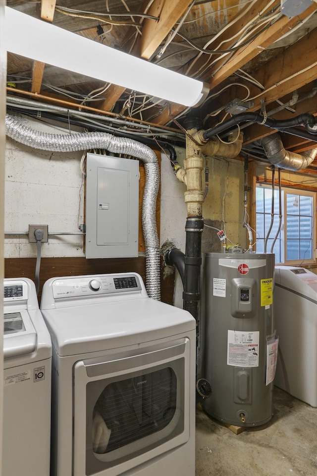 clothes washing area featuring electric panel, separate washer and dryer, laundry area, and water heater