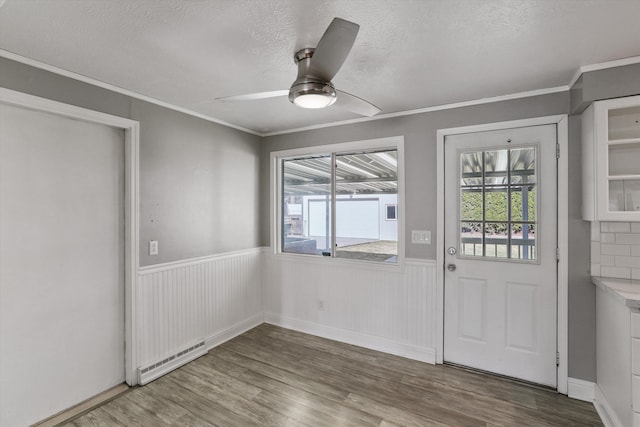 interior space featuring plenty of natural light, wainscoting, and a baseboard radiator