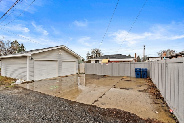 detached garage featuring fence