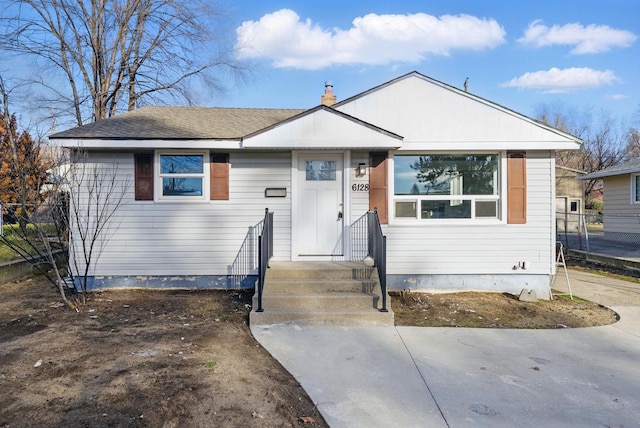 bungalow-style home with fence