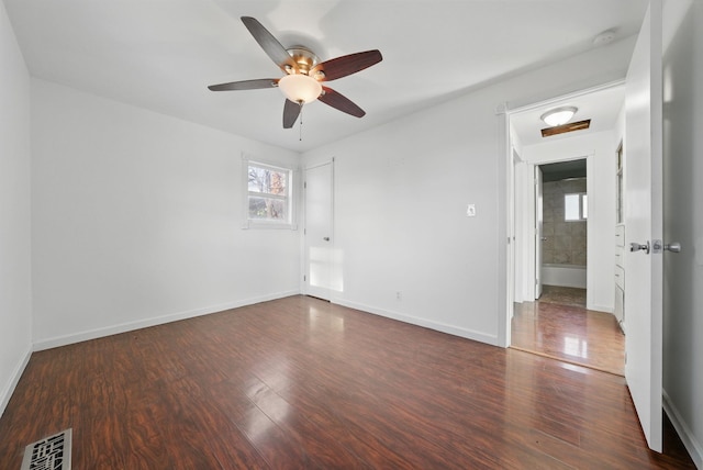 spare room with visible vents, baseboards, ceiling fan, and wood finished floors