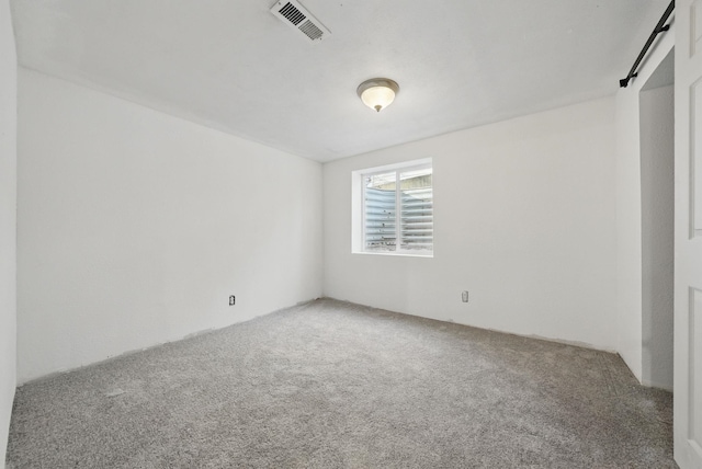 unfurnished room featuring visible vents and carpet flooring