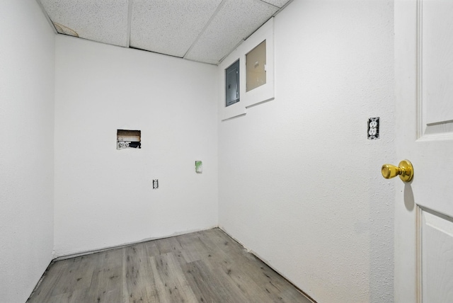 laundry area with laundry area, light wood-style flooring, and washer hookup