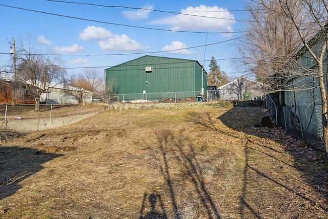 view of yard with an outdoor structure and fence