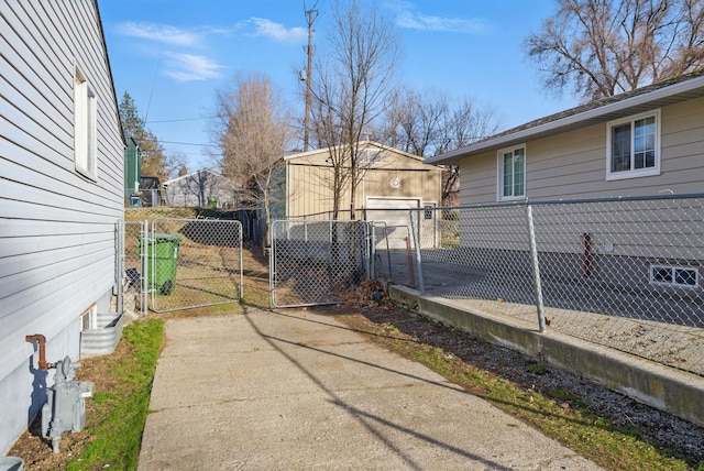 view of property exterior with fence, an outdoor structure, and a gate