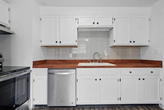 kitchen featuring a sink, under cabinet range hood, tasteful backsplash, white cabinetry, and stainless steel appliances