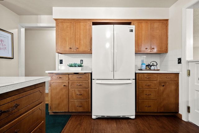 kitchen with light countertops, freestanding refrigerator, and dark wood-style flooring