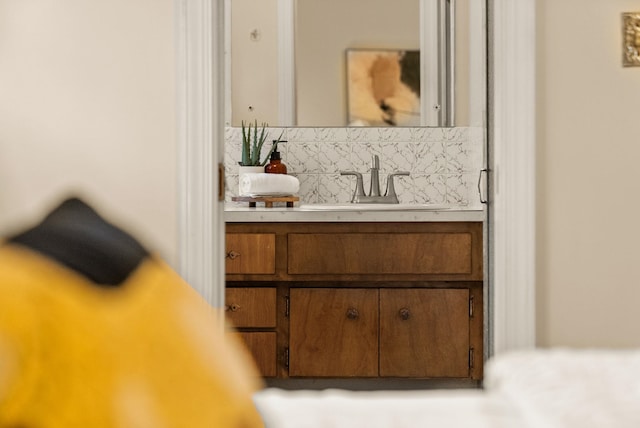 bathroom with tasteful backsplash and vanity