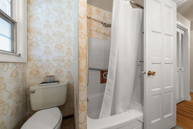 full bathroom with toilet, wood finished floors, shower / tub combo, and wallpapered walls