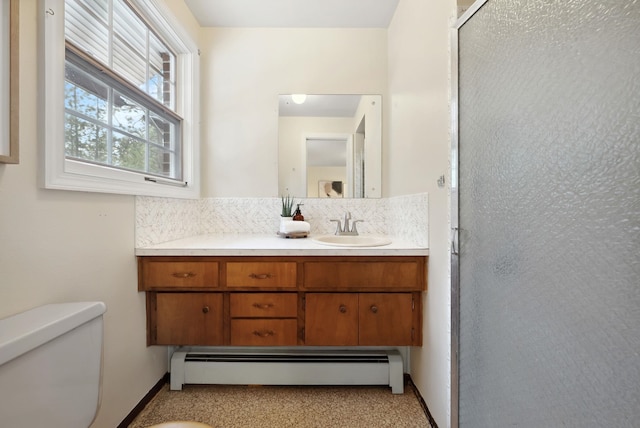 bathroom featuring a shower stall, toilet, baseboard heating, decorative backsplash, and vanity