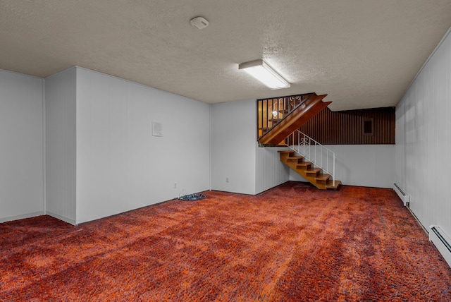 finished basement with stairs, a textured ceiling, carpet flooring, and a baseboard radiator