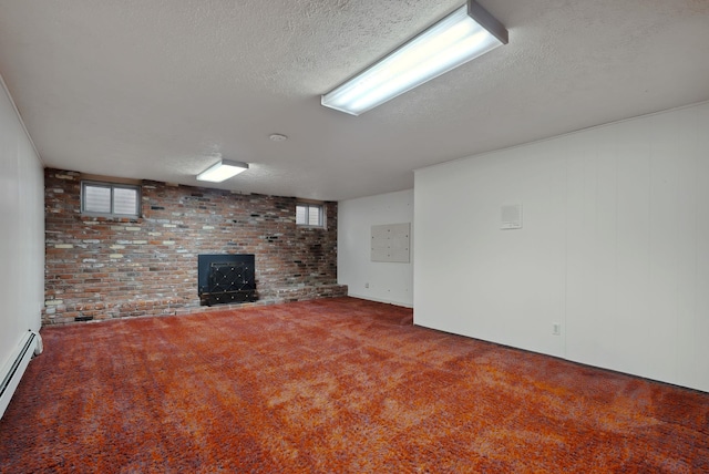 below grade area featuring plenty of natural light, a textured ceiling, baseboard heating, and carpet flooring