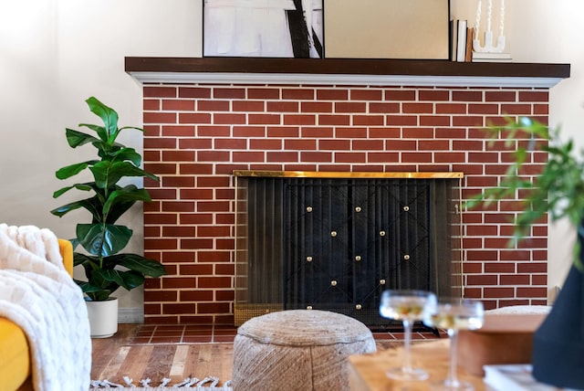 interior details featuring a fireplace and wood finished floors