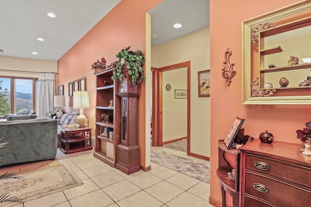 interior space featuring light tile patterned floors, baseboards, and recessed lighting