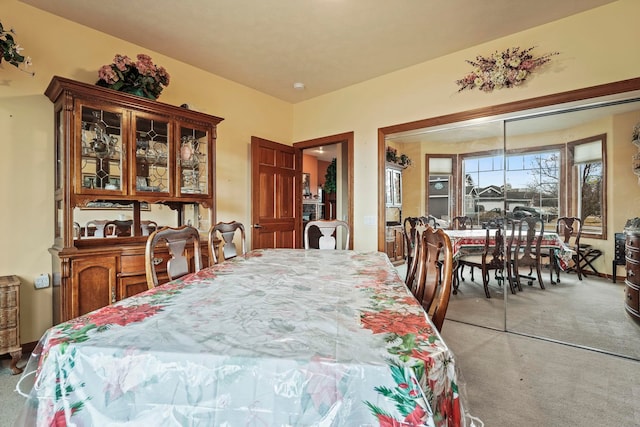 dining area with light colored carpet