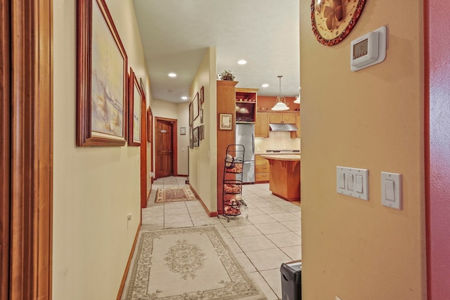 hall featuring light tile patterned floors, baseboards, and recessed lighting