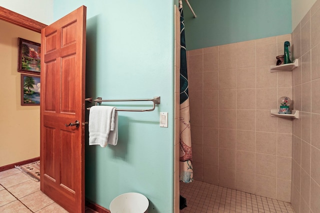 full bathroom with tile patterned floors, baseboards, and a stall shower