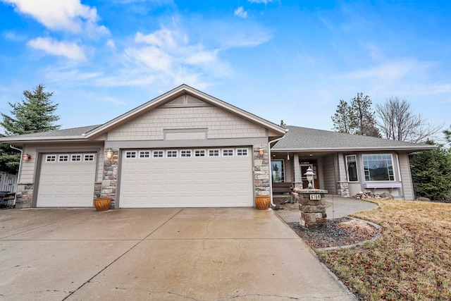 single story home featuring stone siding, driveway, and a garage