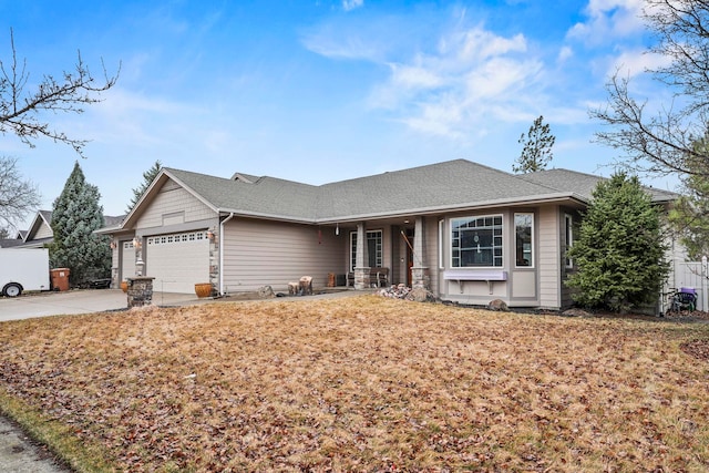 ranch-style home featuring a garage, roof with shingles, and driveway