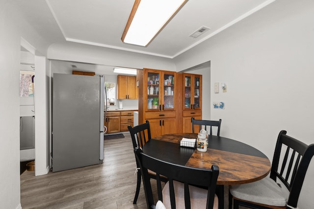 dining room with visible vents and light wood-type flooring