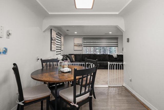 dining room featuring wood finished floors and baseboards