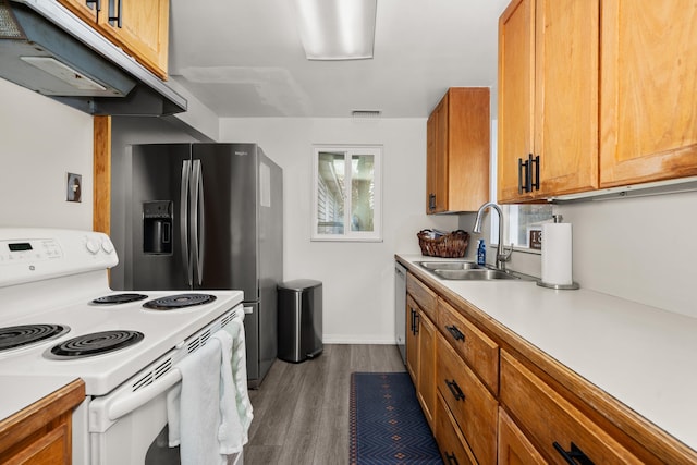 kitchen with dark wood-type flooring, a sink, white electric stove, brown cabinetry, and light countertops