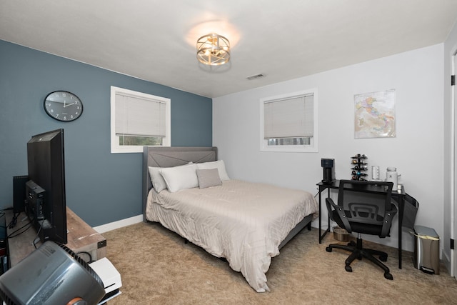 carpeted bedroom with visible vents and baseboards