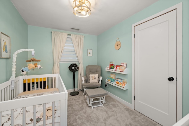 carpeted bedroom with visible vents, a crib, and baseboards