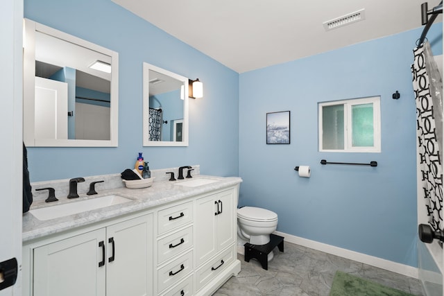 full bath with double vanity, visible vents, toilet, and a sink