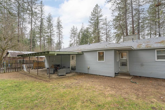 rear view of property featuring a yard