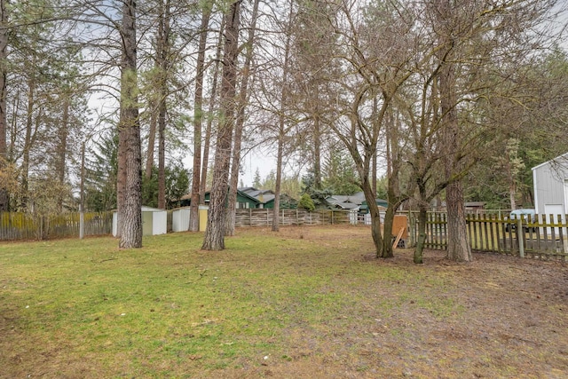 view of yard featuring an outbuilding and fence private yard