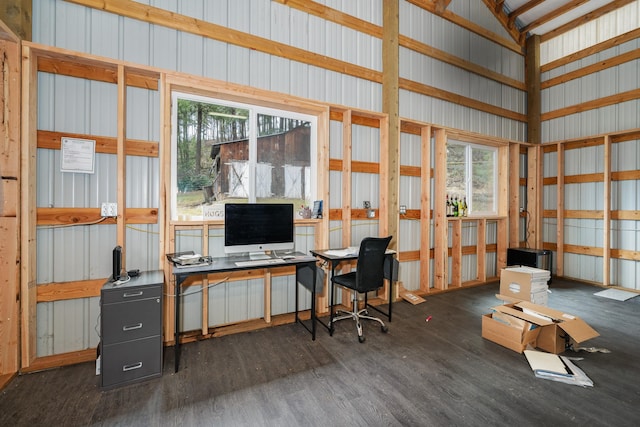 office with dark wood-type flooring and metal wall