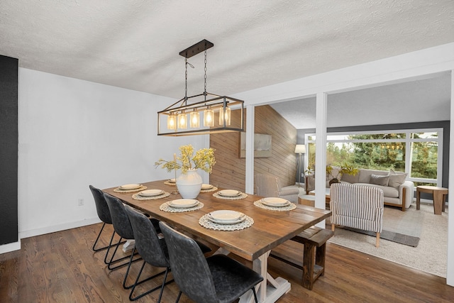 dining area featuring dark wood finished floors and a textured ceiling