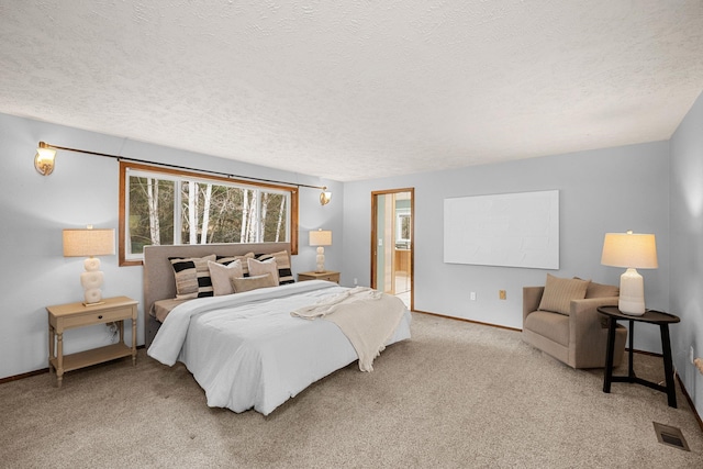 carpeted bedroom featuring visible vents, baseboards, a textured ceiling, and ensuite bathroom