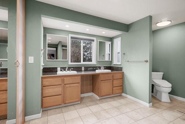 full bathroom featuring a sink, visible vents, toilet, and double vanity