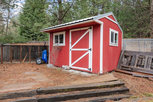 view of shed with fence