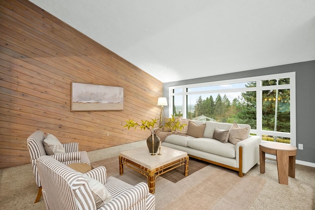 carpeted living room featuring wood walls and lofted ceiling