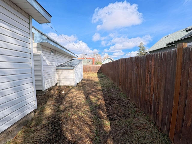 view of yard with an outdoor structure and a fenced backyard